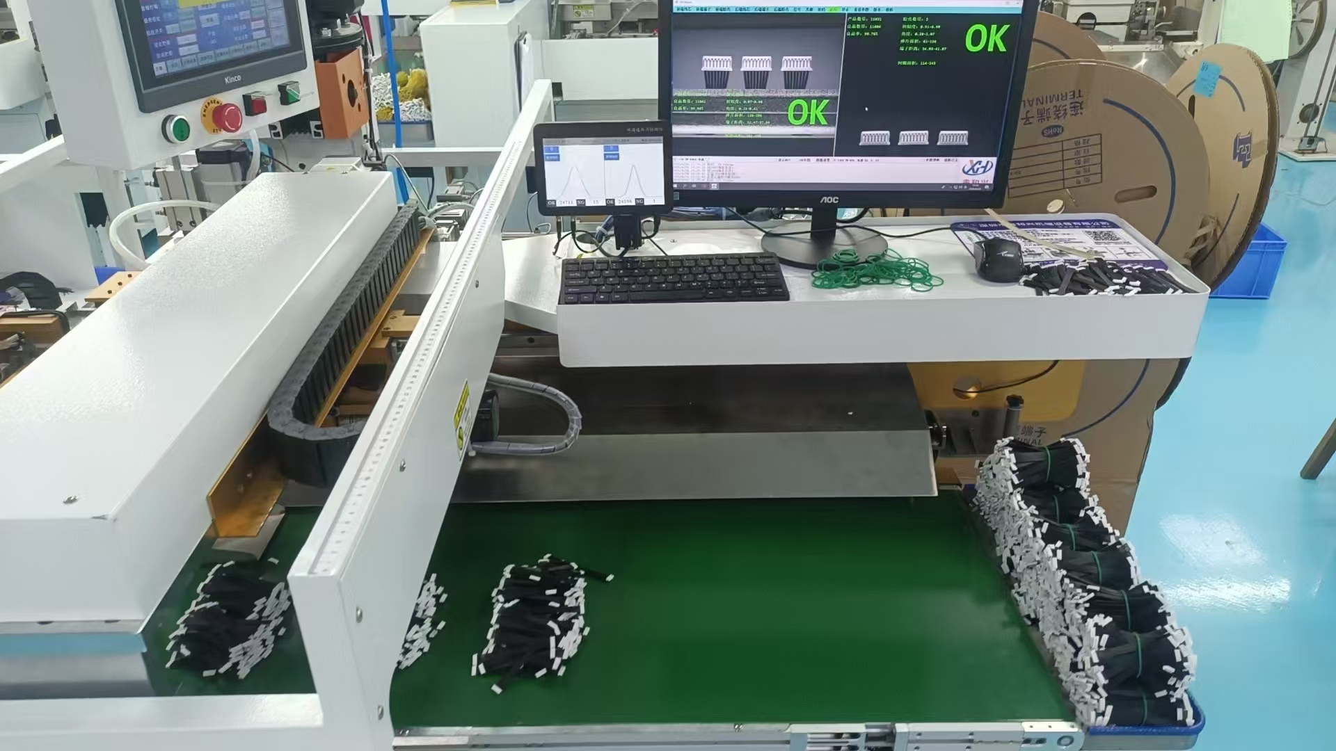 Modern manufacturing facility with advanced production equipment, showing automated assembly lines and quality inspection stations in well-lit industrial setting